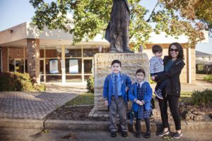 Family standing in front of the Parish building